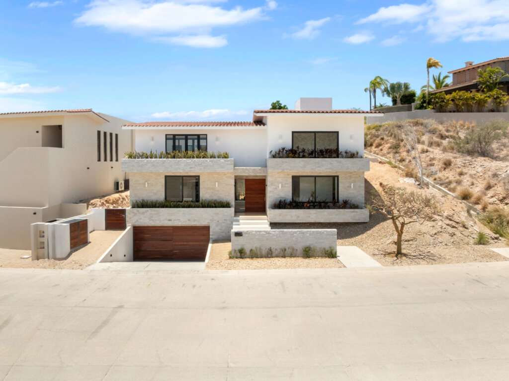 Cabo Luxury Los Valles Sophisticated and solidly built, this 5,588 sq.ft. estate in Club Campestre offers luxury living with exceptional construction quality rarely found in Los Cabos. Residents enjoy exclusive access to a private beach club and world-class golf course, all just minutes from San Jose vibrant dining and culture. The home features 4 ensuite bedrooms, a 3-stop elevator, and a Generac backup system. Entertain in style with a chef's kitchen, wine room with Tzalam wood cabinetry, and an outdoor BBQ area with fire pit. Relax by the heated pool or on the Jacuzzi terrace with partial ocean for sale