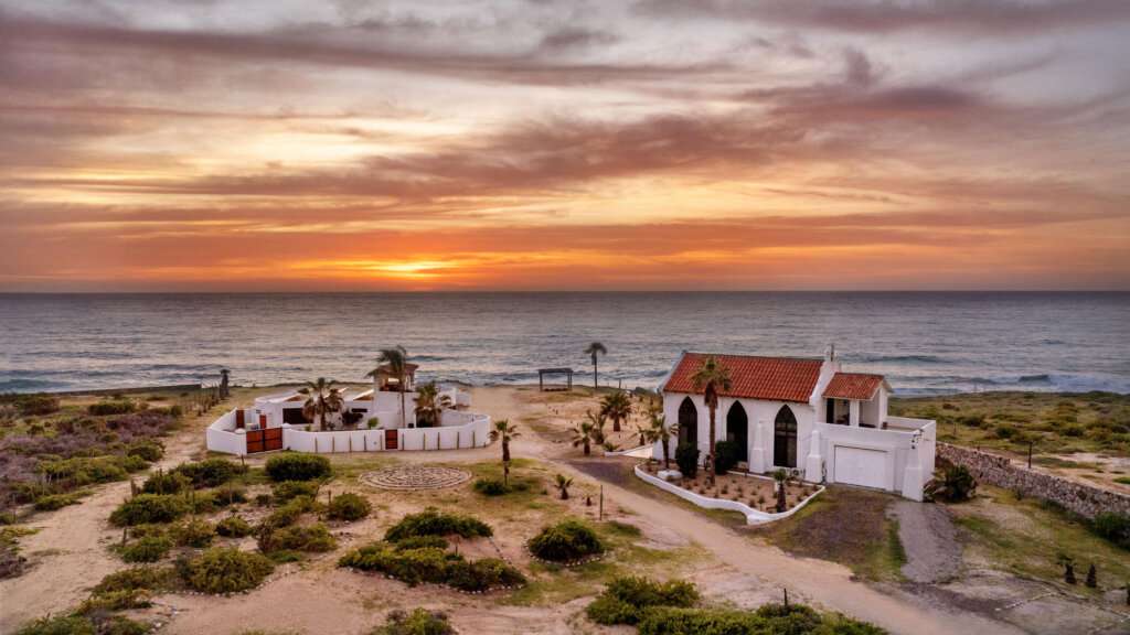 Cabo Luxury Elias Calles Welcome to Rancho 82 -- a rare 2.4-acre oceanfront property offering 190 feet of Pacific coastline, two charming Baja-style homes, and endless potential. With five titled lots, and easy access from Highway 19, this property could become a family compound, boutique retreat, or collection of oceanfront villas. The main home offers 3 bedrooms and 3 baths; the guest casita includes 3 bedrooms, 2 baths, and a rooftop terrace. Both feature authentic Mexican craftsmanship, handmade tiles, and sweeping ocean for sale